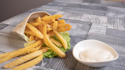 fried potatoes on the table and sauce