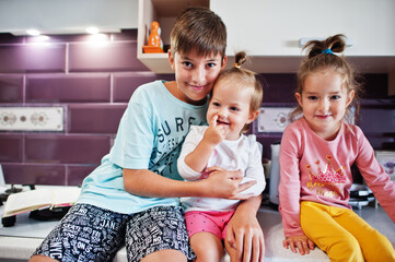 Kids cooking at kitchen, happy children's moments.