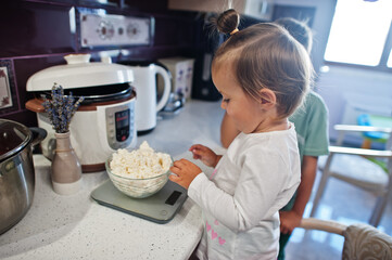 Kids cooking at kitchen, happy children's moments.