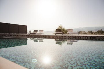 Luxury lap pool with tree and mountains in background