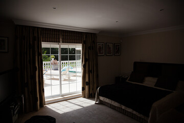 Sun shining through window into luxury bedroom
