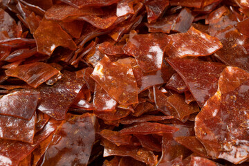 Brown Shellac dry flakes close up full frame as background 