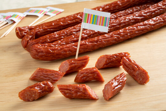 Whole and pieces of smoked polish cabanossi sausages for a snack  