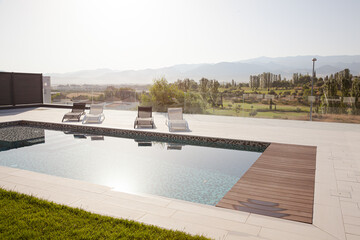 View of trees and mountains behind luxury lap pool