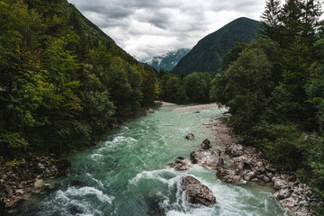 View on Soča river. Panoramic summer view of Julian Alps, Soča valley, Bovec location, Slovenia, Europe. Landscape of Triglav National Park. Traveling concept background.