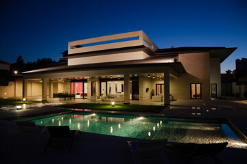 Luxury house and swimming pool illuminated at night