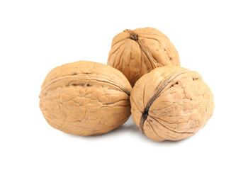 Whole walnuts in shell on white background