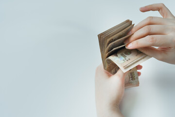 money income and invest concept with woman hand during count thai banknote on white isolated background