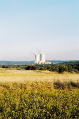 nuclear power station in the middle of nowhere in Spain. Landscape with nuclear power station. Steaming factory producing electricity. Hot summer day. road trip in summer holiday.