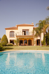 Fototapeta na wymiar Swimming pool and Spanish villa