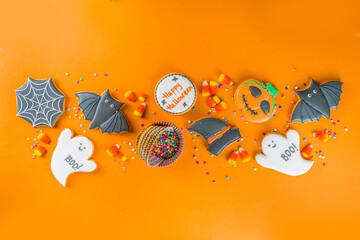 Halloween treats background with sugared Gingerbread cookies and candies, Trick or treat concept top view copy space
