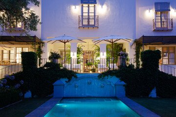Luxury swimming pool and villa illuminated at night