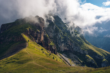 Clouds over the mountains. Panoramic summer view of Julian Alps. Mangart location, Slovenia, Europe. Landscape of Triglav National Park. Traveling concept. 