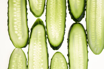 Cucumber green slices pattern isolated on white background. Creative cucumbers wallpaper, food backdrop design