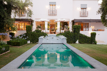 Luxury lap pool and villa at dusk