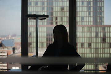 Businesswoman standing in office hallway