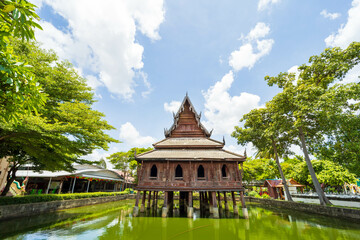 Beautiful of Tripitaka Storage Tower.Thai wooden temple architecture in the middle of the pond at wat Thung Si Muang in Ubon Ratchathani province, Thailand, ASIA.