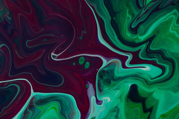 Beautiful liquid texture of the nail polish.Green and purple colors.Multicolored background with copy space.Fluid art,pour painting technique.Good as digital decor.