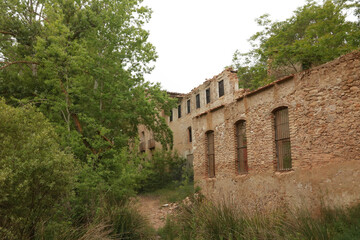 Old abandoned factory in the riverbed in Banyeres of Mariola.