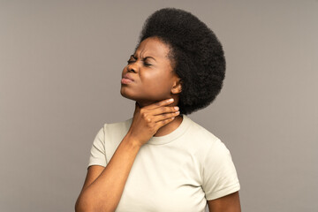 Unhealthy african girl having sore throat, suffering from painful swallowing, strong pain in throat...