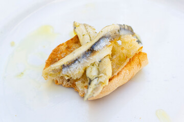 Fish fillet in olive oil and vinegar on bread