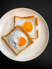 Fried egg in a plate on a table