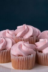 Close up of a plate of pink mini strawberry cupcakes