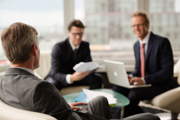 Businessmen sitting in meeting