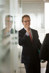 Businessman talking on cell phone in office