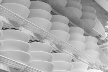 White plates on the showcase close up. White plates in arow