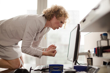 Businesswoman yelling at computer in office