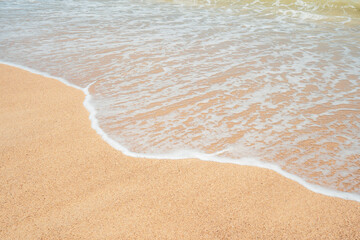 Landscape waves nature splashes sand beach on sunlight.Blue wave and white foamy nature on sunny summer day.
