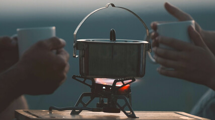 The pan stands over a gas burner outdoor