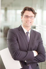 Businessman sitting on sofa in office lobby