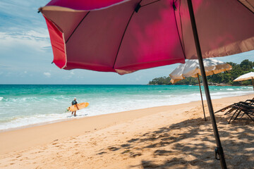 Surfboard and palm tree on beach colorful sky on summer holidays.Surf on sea beach.