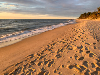Footprints on the sandy beach, sea sand texture 