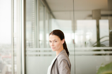 Businesswoman standing at office window