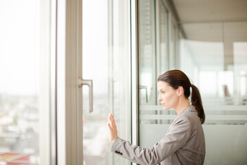 Businesswoman standing at office window