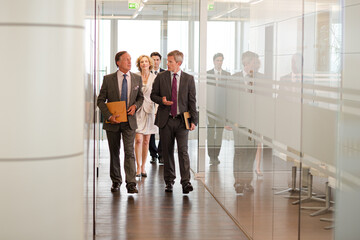 Business people talking in office lobby