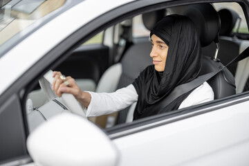 Muslim woman drives a car