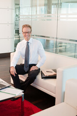 Businessman standing in office hallway