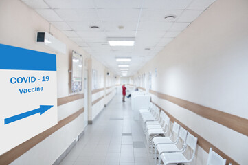 Hospital corridor with a  covid-19 vaccination poster.
