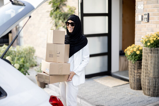Muslim woman carrying parcels home