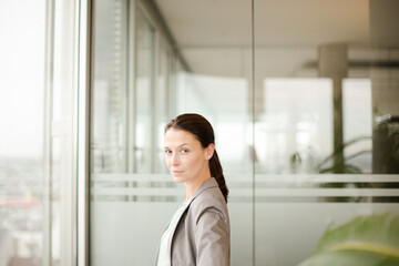 Businesswoman standing at office window