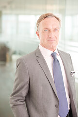 Fototapeta premium Businessman standing in office hallway