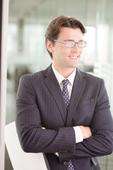 Businessman sitting on sofa in office lobby