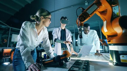 Team of IT engineers are using VR-glasses to operate robots