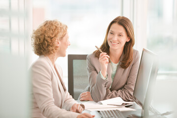 Businesswomen working together at desk