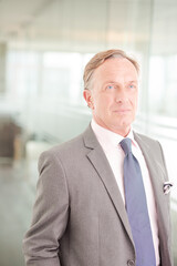 Businessman standing in office hallway