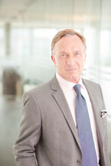 Businessman standing in office hallway